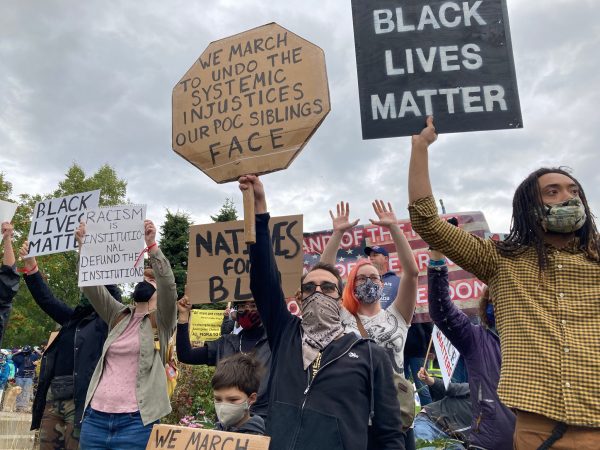 People holding signs that say Black Lives Matter