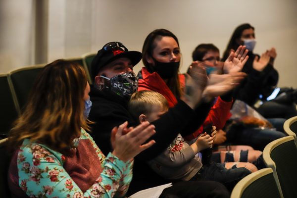 People clap at the Anchorage Assembly meeting.