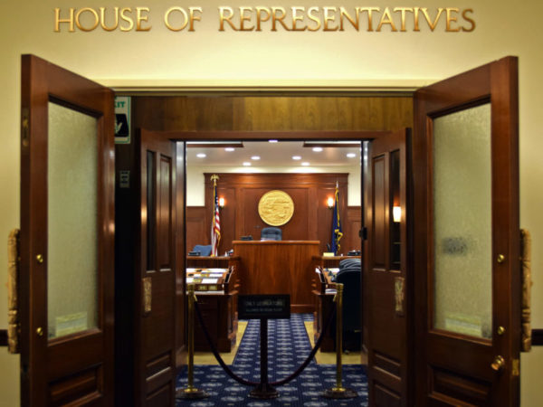 LArge wooden doors opening to a dais