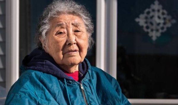 An Alaska Native woman in a blue jacket