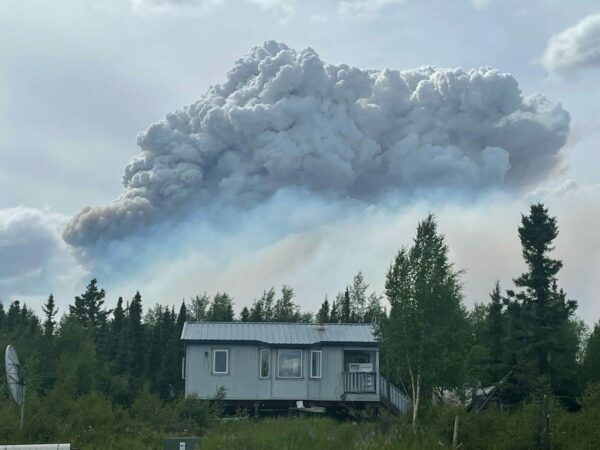 a house with smoke billowing behind it