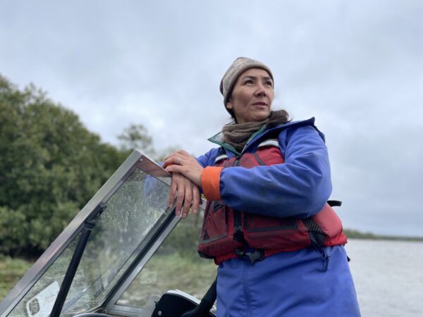 woman at helm of boat